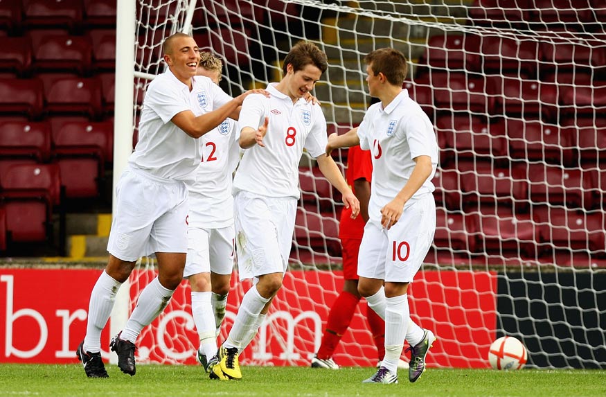 Nick Powell (No.8) is congratulated by team-mates after scoring.